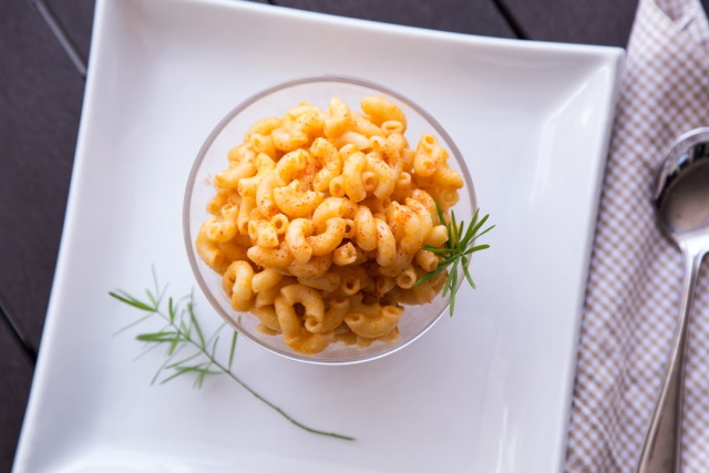 Bowl of paprika dusted mac and cheese on an elegant white plate